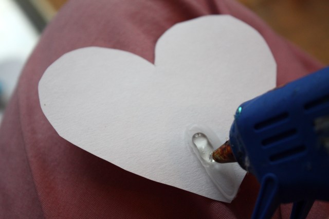 Use a hot glue gun to affix the party horn to the back of the heart.  It holds MUCH better than white glue.